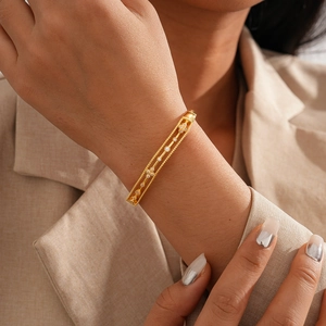 Detailed close-up of 18k gold-plated cuff bracelet featuring a hollow double-row zircon design