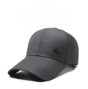 Detail of dark grey baseball cap with a black crown emblem and reinforced stitching