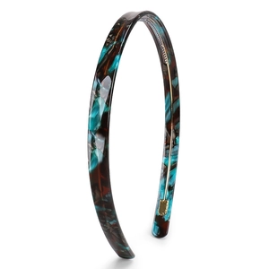 Detail view of thin acetate headband featuring blue and brown tortoiseshell pattern