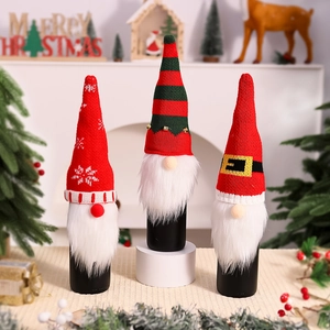 Three festive Christmas gnome wine bottle covers with knitted patterns and faux fur beards