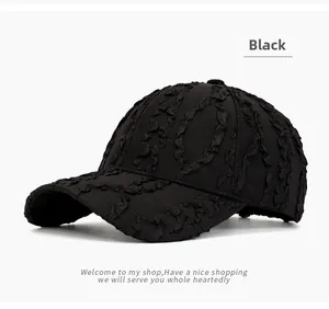 Close-up of black baseball cap featuring unique seersucker pleated texture and fabric detail