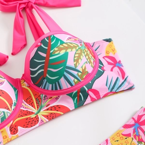 Detail of floral bikini top with tropical leaf print and supportive underwire cups