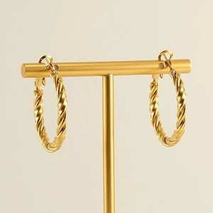 18k gold-plated stainless steel spiral hoop earrings displayed on a professional T-stand