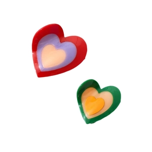 Colorful heart-shaped acetate hair claws in layered red and green candy colors