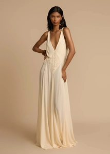 Detail view of lace patchwork and deep V-neck on ivory white summer maxi dress