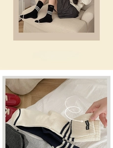 Detail of striped cotton crew socks with label patches and elastic ribbed cuffs