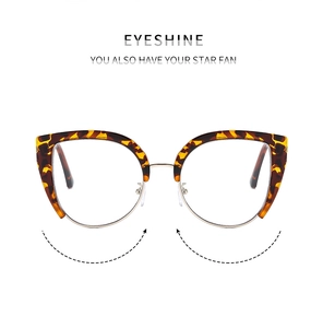 Detail of cat-eye frames featuring tortoiseshell texture and golden metal lower rims