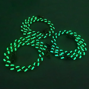 Three glowing green luminous Cuban link necklaces for men in a dark hip hop style