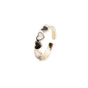 Close-up of golden adjustable open ring with black and white enamel heart charms