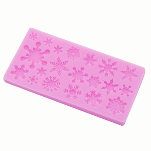 Pink silicone mold featuring multiple snowflake patterns for Christmas fondant cake decorating
