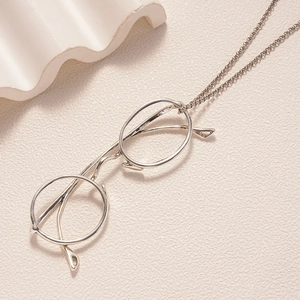 Macro shot of silver metal glasses pendant showing bridge and temple details