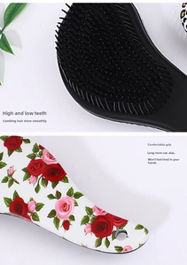Detail of ergonomic hairbrush handle with pink rose pattern and dual-length bristles