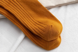 Detail shot showing the refined toe seam of ginger yellow ribbed cotton crew socks