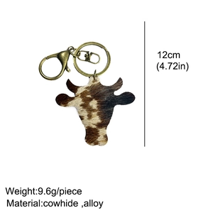 Detail shot of vintage leather bull head keychain showing 12cm length and 9.6g weight
