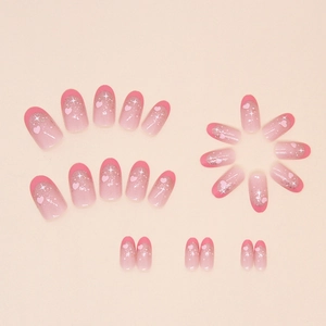 Pink gradient oval press-on nails with heart patterns and glitter accents