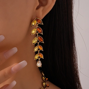 Macro shot of retro drop earrings with champagne crystals and golden wheat leaves