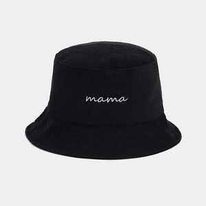 Detailed close-up of white mama embroidery on a black cotton bucket hat for women