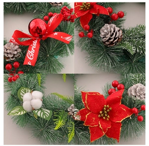 Detail of Christmas wreath featuring red Merry Christmas ribbon, pine cones and berries