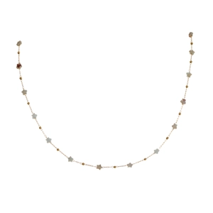 Close-up of golden chain necklace with grey star beads and tiny gold spheres
