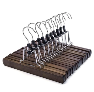 Close-up of solid walnut wood skirt hangers with adjustable non-slip metal clips