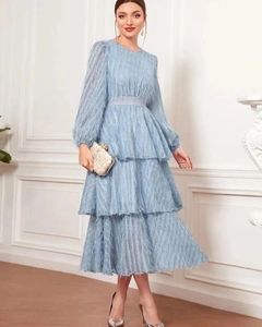 Detail of light blue tiered tassel dress with feather texture and long sleeves