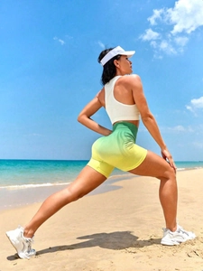 Outdoor macro of high-waist peach lift yoga shorts in green yellow gradient fabric