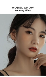Close-up of polished silver hoop earrings on model showing minimalist retro style