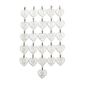 Macro view of heart-shaped shell pendants featuring silver edges and A-Z alphabet letters