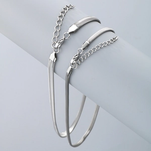 Detail of two silver stainless steel flat snake chain bracelets with lobster clasps