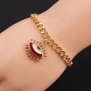 Detail of colorful Evil Eye charm bracelet with red and white enamel on a gold chain