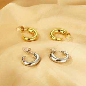 Minimalist C-shaped thick hoop earrings in gold and silver finish on silk fabric