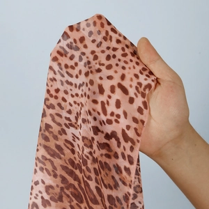 Detail of leopard print mesh fabric showing sheer texture and stylish animal patterns