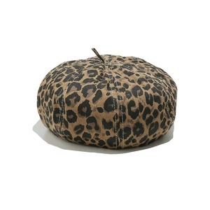 Close-up of leopard print pattern and fabric texture on a stylish beret hat