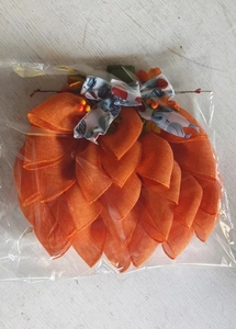 Detailed view of handmade pumpkin door wreath with orange mesh fabric and a patterned bow