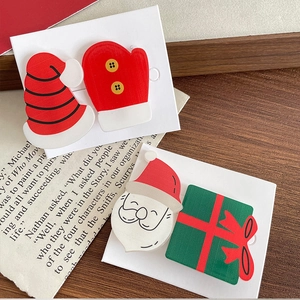 Cute Christmas hair clips set with Santa, gift box, and hat icons on card backings