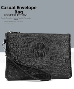 Detail of black crocodile texture envelope clutch bag with metal zipper and wrist strap