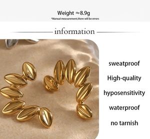 Detailed view of gold leaf hoop earrings highlighting 8.9g weight and waterproof features