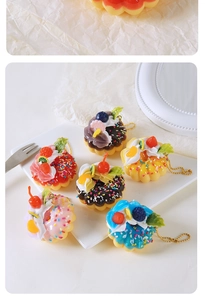 Set of six colorful simulation fruit donuts with cream toppings and golden chains