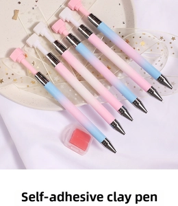 Macro shot of 7 gradient macaron dotting pens and pink glue clay for nail art decoration