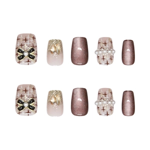 Handmade brown cat eye press-on nails with champagne diamonds and pearl bows