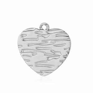 Macro detail of silver stainless steel heart pendant with rustic bark texture