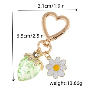 Detail showing dimensions of strawberry and daisy keychain with heart-shaped gold clasp