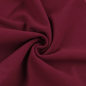 Detailed macro view of the wine red fabric texture with soft drape and elegant folds