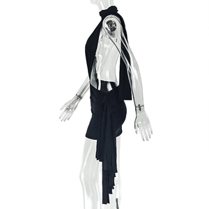 Detail of black slim-fit dress featuring scarf halter neck and side ribbon ties