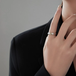 Minimalist silver lava texture open ring with yellow gemstone on model's finger