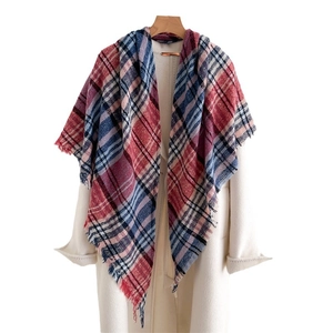 Classic red and blue plaid faux cashmere scarf with tassels styled over a beige coat