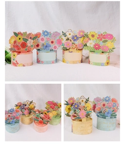 Detail view of 4 floral 3D pop-up greeting cards in pink, blue, yellow and green colors
