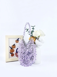 Detailed view of purple faceted acrylic beaded handbag with clear resin beads and top handle