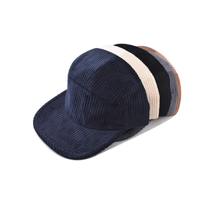 Detail showing five colors of retro 5-panel corduroy caps with textured fabric