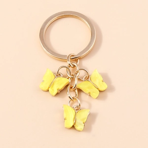 Sweet acrylic butterfly keychain with three yellow marble charms on a gold chain ring